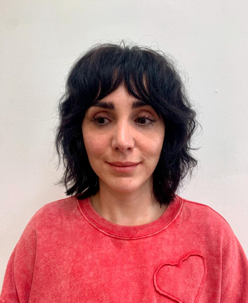 Shoulder length haircut with shaggy layers and curtain bangs